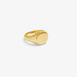 ICED London gold signet ring with smooth oval face, polished band, close-up product shot.
