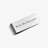 ICED London metal wallet, brushed silver finish, engraved Gothic text “Broke But Organized.”